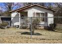 A charming one-story home with a cozy front porch and fenced yard, inviting comfort and security at 309 Cody St, Durham, NC 27703