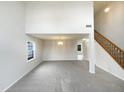 Spacious living room with soaring ceilings and neutral carpet at 4 Birkdale Ct, Durham, NC 27713