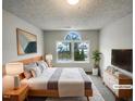 A well-lit main bedroom featuring a large window, comfortable bed, and modern furnishings at 4 Birkdale Ct, Durham, NC 27713