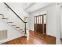 Bright foyer boasts hardwood floors, staircase, and elegant front door with glass detailing at 419 Eagle Point Rd, Pittsboro, NC 27312