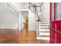 Entryway featuring hardwood floors, staircase, and view into the nearby kitchen area at 419 Eagle Point Rd, Pittsboro, NC 27312