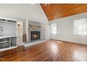 Cozy living room with a stone fireplace, hardwood floors, and a wood paneled vaulted ceiling at 419 Eagle Point Rd, Pittsboro, NC 27312