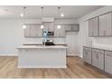 Well-lit kitchen featuring granite countertops, stainless appliances, and an island at 505 Providence Springs Ln, Fuquay Varina, NC 27526