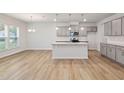 Open kitchen with granite island, modern appliances and ample counter space at 505 Providence Springs Ln, Fuquay Varina, NC 27526