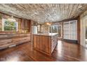 Rustic kitchen boasts custom wood cabinets and island with granite countertops at 513 W Glendale St, Siler City, NC 27344