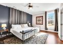 Spacious bedroom featuring hardwood floors, large windows and tasteful decor at 606 E Mason St, Franklinton, NC 27525