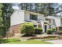 Charming townhouse displaying traditional architecture with a manicured front lawn and entryway at 7708 Falcon Rest Cir, Raleigh, NC 27615