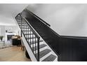 Modern staircase with black rails and white risers, leading to the upper level at 7708 Falcon Rest Cir, Raleigh, NC 27615