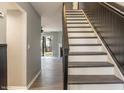 Elegant staircase with white risers and wood treads, leading to the upper level at 7708 Falcon Rest Cir, Raleigh, NC 27615