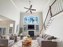 Bright living room features a fireplace, large windows and beautiful hardwood floors at 9100 Palm Bay Cir, Raleigh, NC 27617