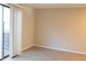 Bright bedroom featuring light-colored wood flooring, neutral walls, and sliding glass doors to a private balcony at 106 Weatherstone Dr # B, Chapel Hill, NC 27514