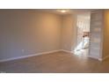 Spacious living room with light wood flooring and neutral paint, next to an open kitchen and built in storage shelves at 106 Weatherstone Dr # B, Chapel Hill, NC 27514