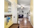 Inviting hallway featuring hardwood floors and a view into the living room, enhancing the home's open feel at 10923 Selma Rd, Middlesex, NC 27557