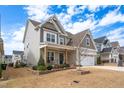Inviting two-story home with a well-manicured lawn and attached two-car garage at 1530 Armscroft Ln, Apex, NC 27502