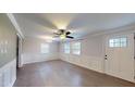Living room with natural light, ceiling fan, and white wainscoting along the walls at 206 Justice Heights St, Apex, NC 27502