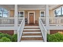 Inviting front porch features classic white railings and stairs, offering a warm welcome to guests at 2505 Francis St, Durham, NC 27707