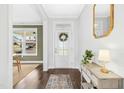 Bright and inviting foyer with hardwood floors, a decorative mirror, and elegant console table at 26 Stone Bridge Xing, Chapel Hill, NC 27517