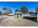 Spacious backyard with a charming gazebo, a storage shed, and a chain link fence at 2608 Walley St, Rocky Mount, NC 27803