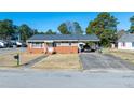Charming brick home with an inviting entrance, covered parking, and lovely curb appeal at 2608 Walley St, Rocky Mount, NC 27803