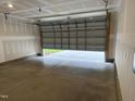 Spacious garage with an open overhead door, showing unfinished drywall and a concrete floor at 338 Tormore Dr, Homesite 123, Sanford, NC 27330