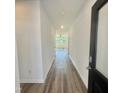 Inviting hallway with wood-look flooring leading to a bright living area with abundant natural light at 338 Tormore Dr, Homesite 123, Sanford, NC 27330