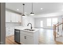 Bright kitchen featuring stainless steel appliances, modern white cabinets, and a central island sink at 357 Church St # 61, Wendell, NC 27591