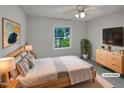Bright bedroom featuring natural light, ceiling fan, and modern furniture at 3908 Sturbridge Dr, Durham, NC 27713