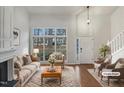 Bright living room with vaulted ceilings, fireplace, large windows, and modern staging at 3908 Sturbridge Dr, Durham, NC 27713