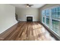 Bright living room with fireplace, hardwood floors, and large windows offering lots of natural light at 4 Strowd Ct, Durham, NC 27703