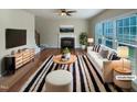 Bright living room with a fireplace, hardwood floors, and lots of natural light, virtually staged at 4 Strowd Ct, Durham, NC 27703