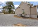Exterior view of the home featuring gravel driveway and central air conditioning unit at 408 Charlotte Ave, Sanford, NC 27330