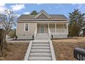 Inviting single-story home with a classic porch, gray stairs, and a well-maintained exterior at 408 Charlotte Ave, Sanford, NC 27330