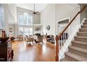 Bright, spacious living room with high ceilings, hardwood floors, fireplace, and natural light from large windows at 500 Chandler Grant Dr, Cary, NC 27519