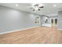 Spacious living area with hardwood floors, ceiling fan, and ample natural light, seamlessly connected to the kitchen at 507 W Edwards St, Princeton, NC 27569