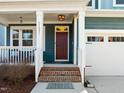 Inviting front entrance with a brick staircase, a red door, and a storm door at 5121 Windmere Chase Dr, Raleigh, NC 27616