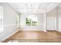 Elegant dining room featuring coffered ceilings, hardwood floors, and large windows at 5372 Salem Woods Dr # 18, Graham, NC 27253