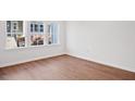 Sunlit bedroom with wood floors and large windows overlooking the exterior at 602 Hyperion Aly, Wake Forest, NC 27587