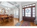 This dining room features hardwood floors, a coffered ceiling and natural light at 6205 Roles Saddle Dr, Rolesville, NC 27571