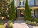Close-up view of the front door with sidelights, decorative wreath, and landscaped walkway at 6205 Roles Saddle Dr, Rolesville, NC 27571
