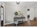 Welcoming entryway with hardwood floors, console table with decorative mirror and wreath at 85 Willow Bend Dr, Youngsville, NC 27596