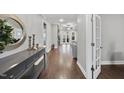 Inviting entryway featuring gleaming hardwood floors and a stylish console table with decorative accents at 85 Willow Bend Dr, Youngsville, NC 27596