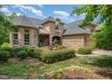 Charming two-story home with beautiful stone and brickwork, a well-maintained lawn, and manicured landscaping at 101 Tussled Ivy Way, Cary, NC 27513