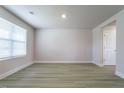 Spacious bedroom with a large window, neutral walls, and wood-look vinyl flooring at 102 Wilderness Ct, Mebane, NC 27302