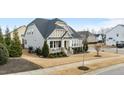 Attractive home featuring a manicured front lawn, a comfortable front porch, and timeless architectural style at 1024 Traditions Ridge Dr, Wake Forest, NC 27587