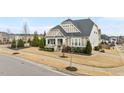 Inviting home displaying a landscaped front yard, a cozy front porch, and traditional exterior elements at 1024 Traditions Ridge Dr, Wake Forest, NC 27587