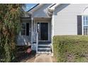 Inviting front door with a well-maintained entrance and tidy landscaping at 103 Poplar Dr, Clayton, NC 27520
