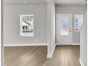 Bright living room features light hardwood floors, neutral walls, and white trim, filled with natural light at 104 Wilderness Ct, Mebane, NC 27302