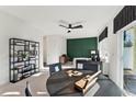 Comfortable living area featuring modern decor, a table, an accent wall, and natural light streaming through windows at 10616 Pleasant Branch Dr # 11, Raleigh, NC 27614