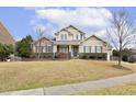Inviting two-story home featuring a combination of stone and siding, set on a spacious front lawn at 115 Vintage Hill Cir, Apex, NC 27539
