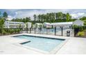 Community pool with a zero entry and baby pool surrounded by lounge chairs and umbrellas at 1210 Tannin Dr, Durham, NC 27713